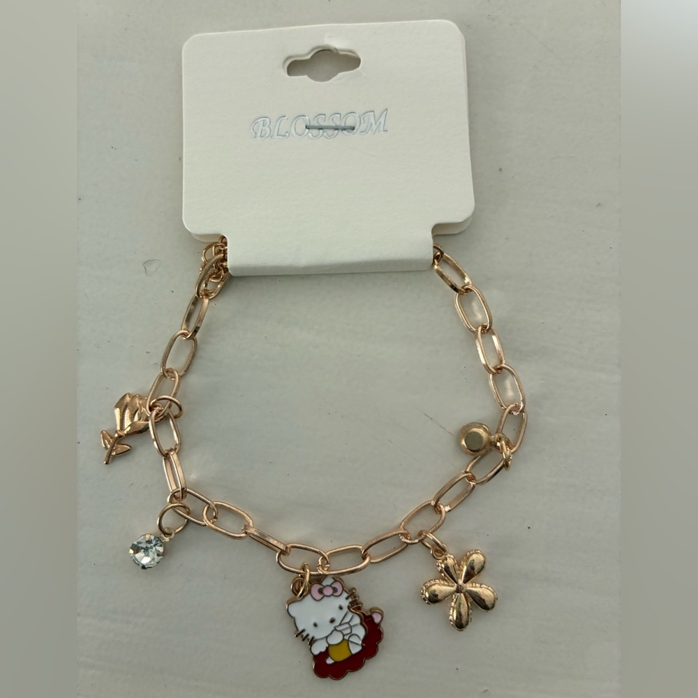 NWT Gold Hello Kitty Charm Bracelet with other designs. Brand new.
